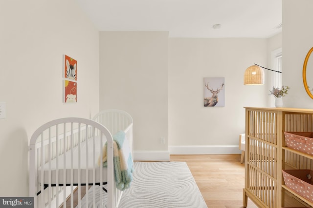 bedroom with light wood-style floors and baseboards