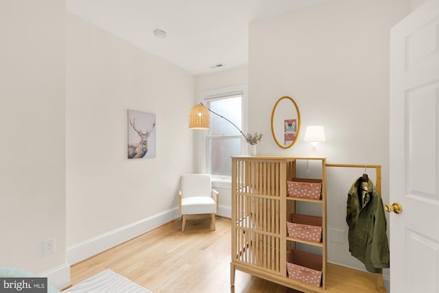 bedroom featuring visible vents, baseboards, and wood finished floors