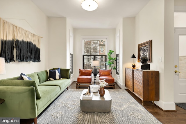 living room featuring dark wood-style floors and baseboards