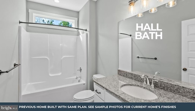 bathroom with  shower combination, vanity, and toilet