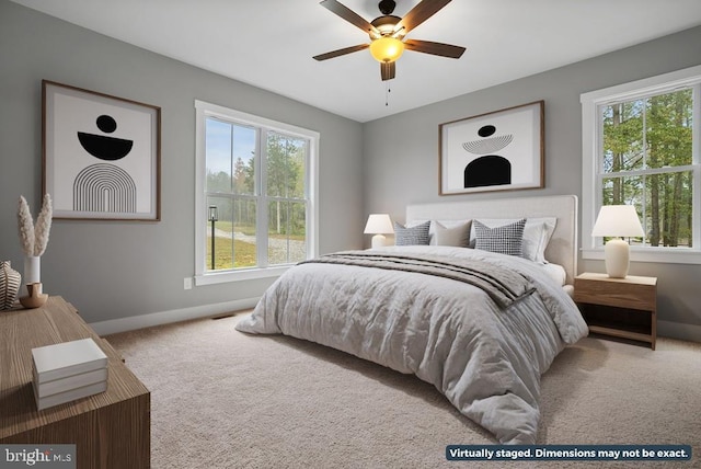 bedroom featuring multiple windows, carpet, and baseboards