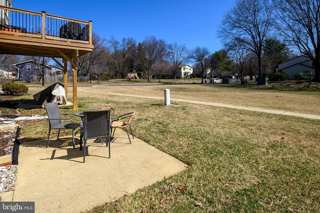 view of yard with a patio area and a wooden deck