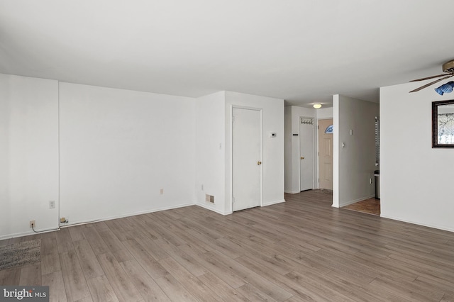 unfurnished room featuring visible vents, light wood-style floors, and ceiling fan