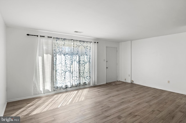 spare room with visible vents and wood finished floors