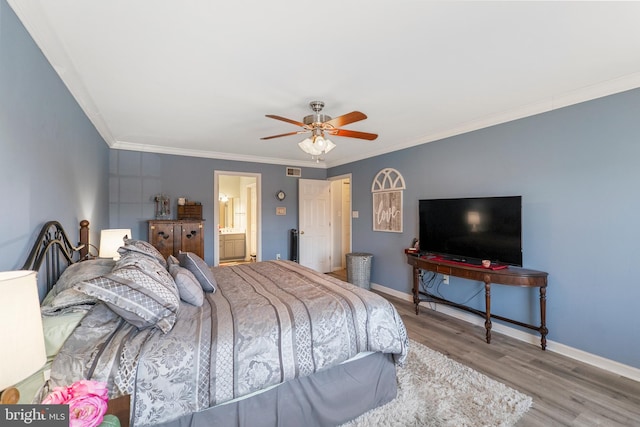 bedroom with visible vents, crown molding, baseboards, and wood finished floors