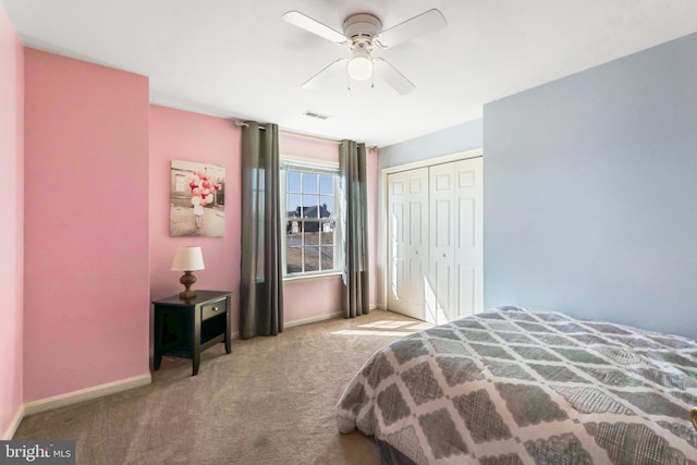 carpeted bedroom with a closet, visible vents, ceiling fan, and baseboards