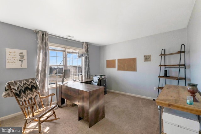 carpeted home office with baseboards and visible vents