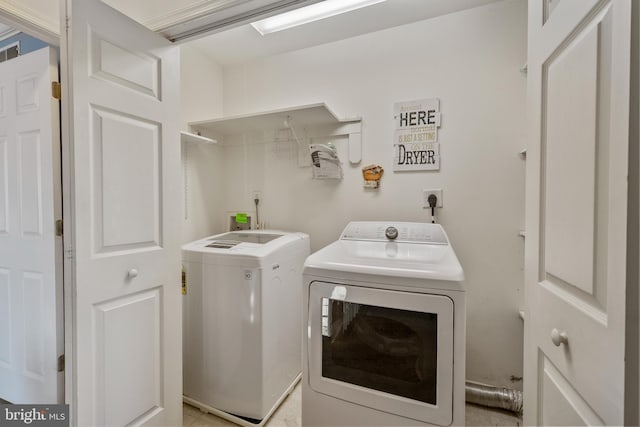 washroom featuring laundry area and washer and dryer