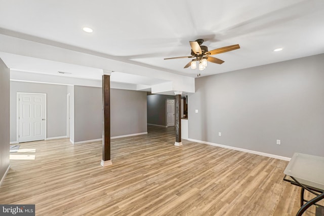 finished basement with light wood-style floors, recessed lighting, and baseboards