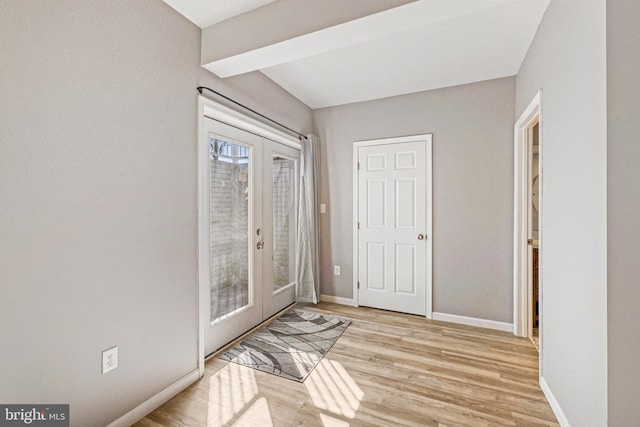 doorway featuring light wood finished floors, french doors, and baseboards