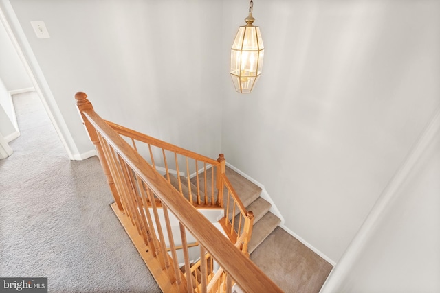 stairway featuring carpet floors and baseboards