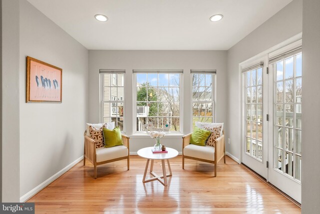 living area with recessed lighting, baseboards, and hardwood / wood-style flooring