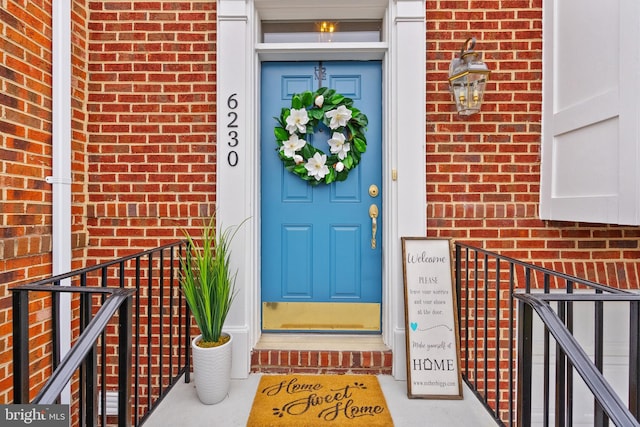 doorway to property with brick siding