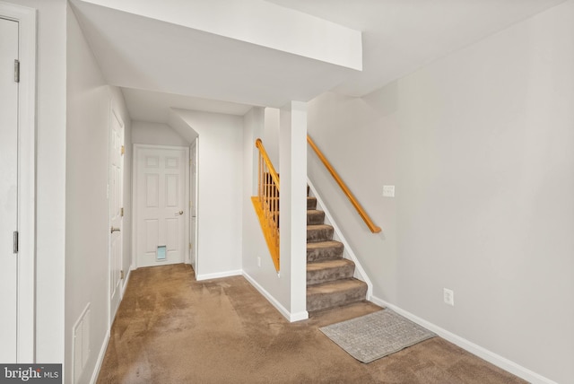 stairway with carpet flooring, visible vents, and baseboards