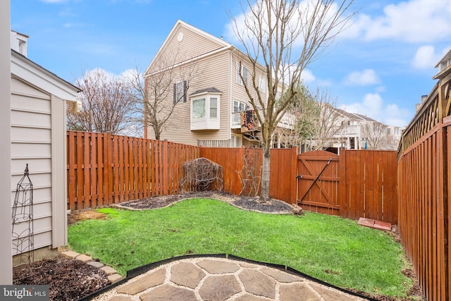 view of yard featuring a fenced backyard and a gate