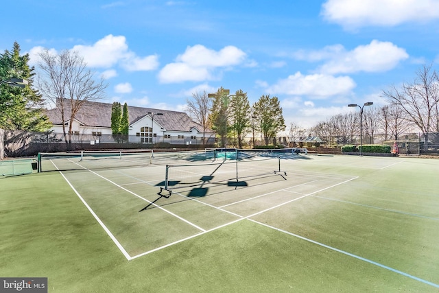 view of sport court featuring fence