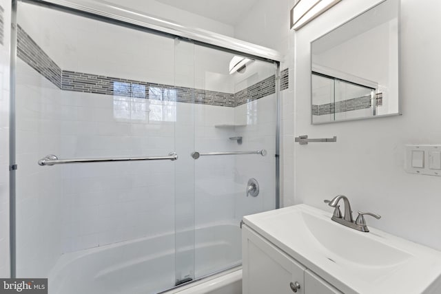 bathroom with combined bath / shower with glass door and vanity