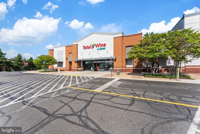 view of building exterior with uncovered parking