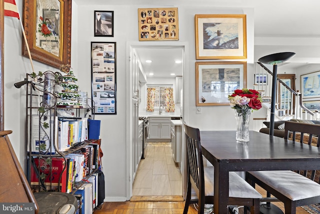 dining space featuring stairway and recessed lighting