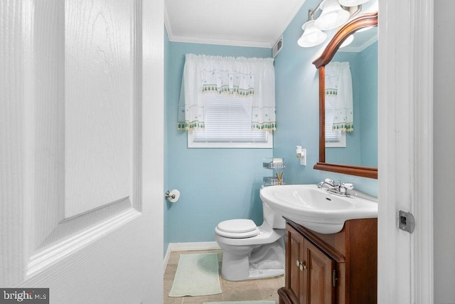 half bath with crown molding, visible vents, toilet, vanity, and baseboards