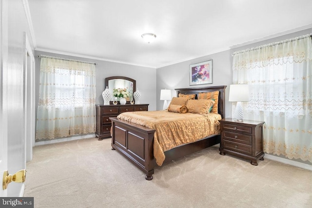 bedroom with baseboards, crown molding, and light colored carpet