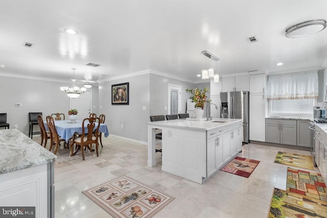 kitchen with a notable chandelier, visible vents, appliances with stainless steel finishes, and a sink