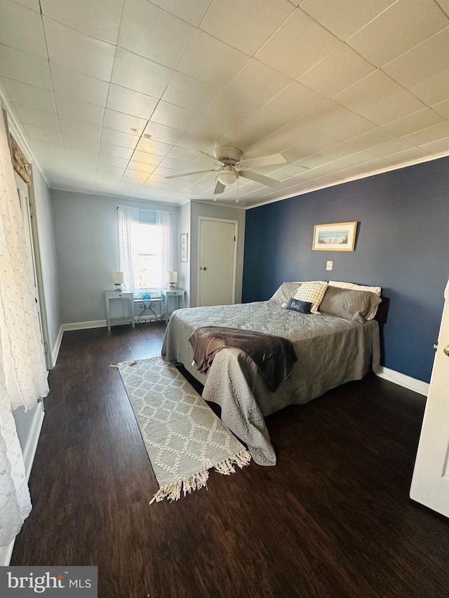 bedroom with dark wood finished floors, baseboards, and ceiling fan