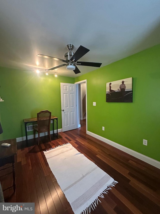 bedroom with dark wood-style flooring and baseboards