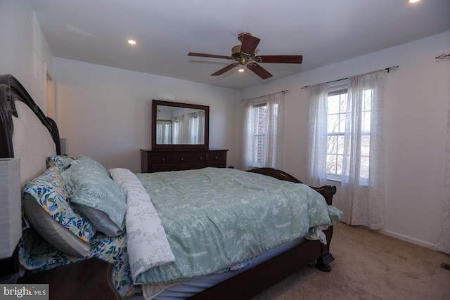 carpeted bedroom with ceiling fan, visible vents, baseboards, and recessed lighting