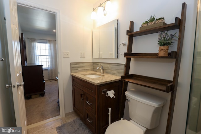 bathroom featuring toilet and vanity