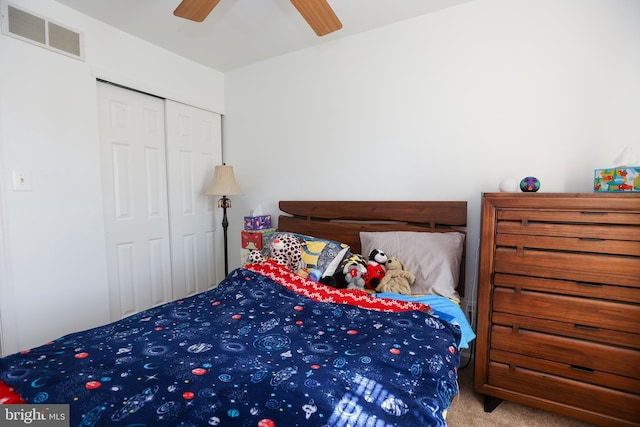 bedroom with ceiling fan, a closet, carpet flooring, and visible vents