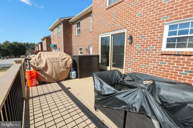 wooden deck featuring a grill