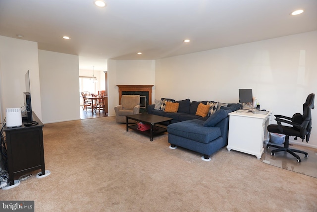 living area featuring carpet, a fireplace, and recessed lighting