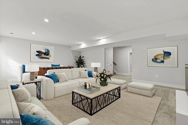 living room featuring recessed lighting, light colored carpet, stairway, and baseboards