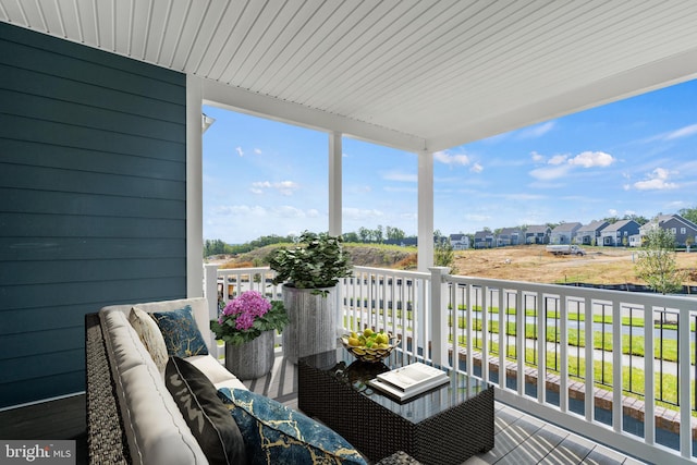 balcony with a residential view and an outdoor hangout area