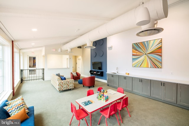 recreation room with baseboards, light colored carpet, vaulted ceiling, a sink, and recessed lighting