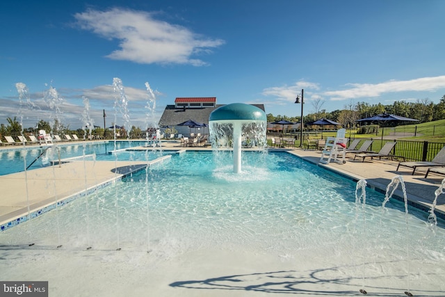 community pool featuring a patio area and fence