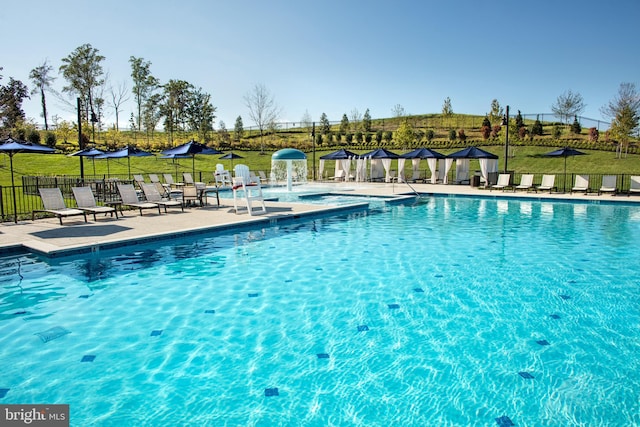 pool with a yard, a patio area, and fence