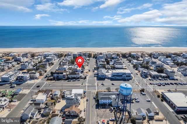 drone / aerial view with a beach view and a water view