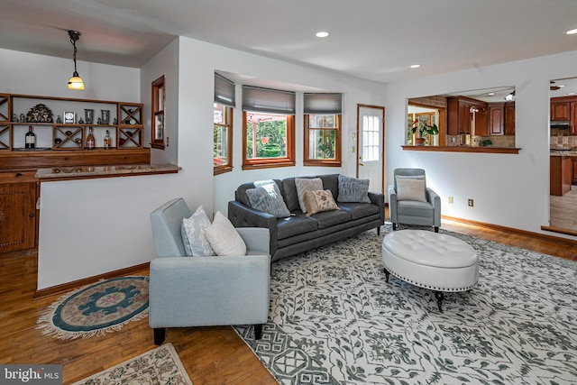 living area featuring wood finished floors, recessed lighting, and baseboards