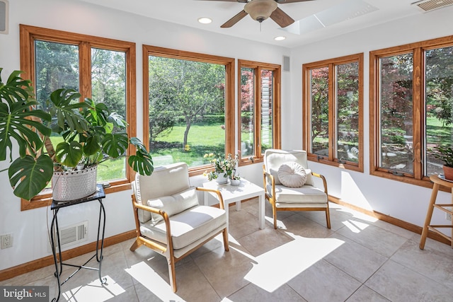sunroom / solarium featuring baseboards, tile patterned flooring, and recessed lighting