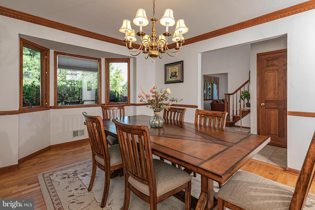dining space with stairway, a chandelier, light wood-style flooring, crown molding, and baseboards
