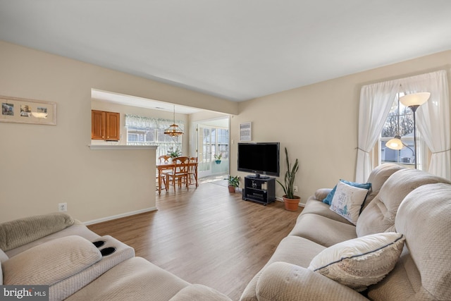 living room featuring baseboards and light wood-style floors