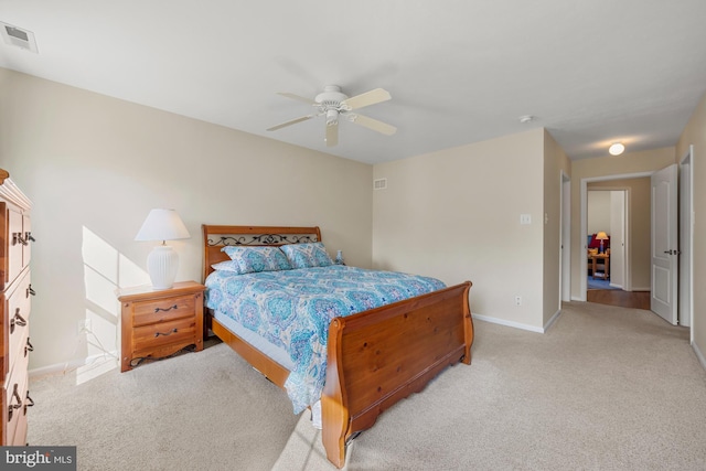 bedroom with light colored carpet, visible vents, and baseboards