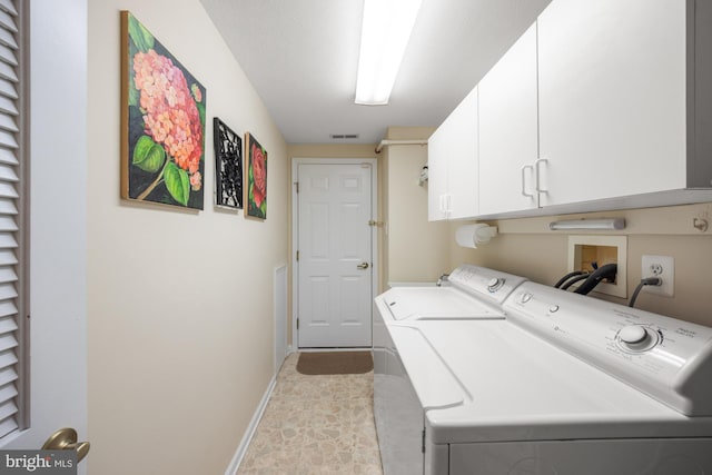 washroom with visible vents, cabinet space, washer and clothes dryer, and baseboards