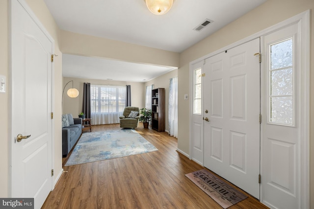 entryway with wood finished floors and visible vents