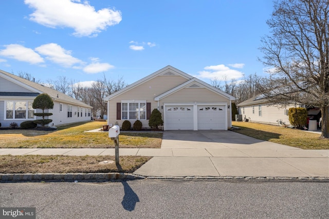 view of front of home with a garage, concrete driveway, and a front lawn