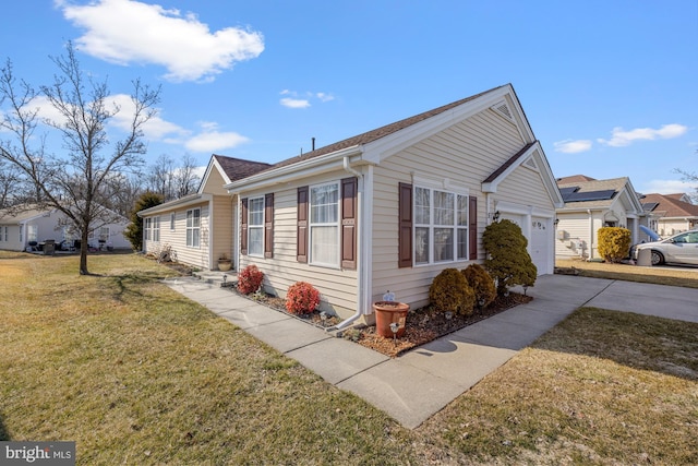 view of property exterior featuring a yard, an attached garage, and driveway