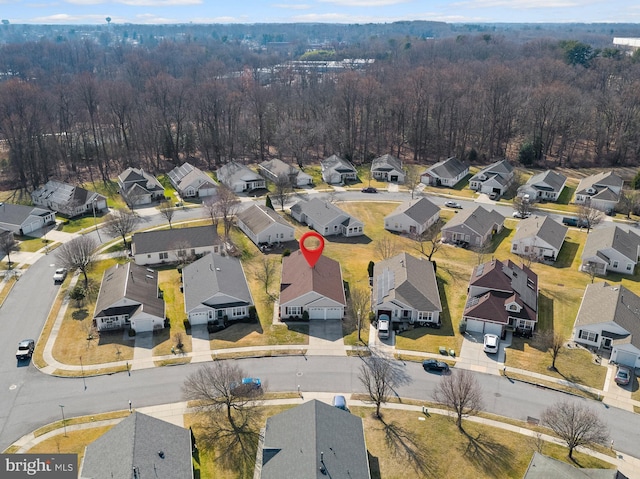 birds eye view of property featuring a residential view and a view of trees