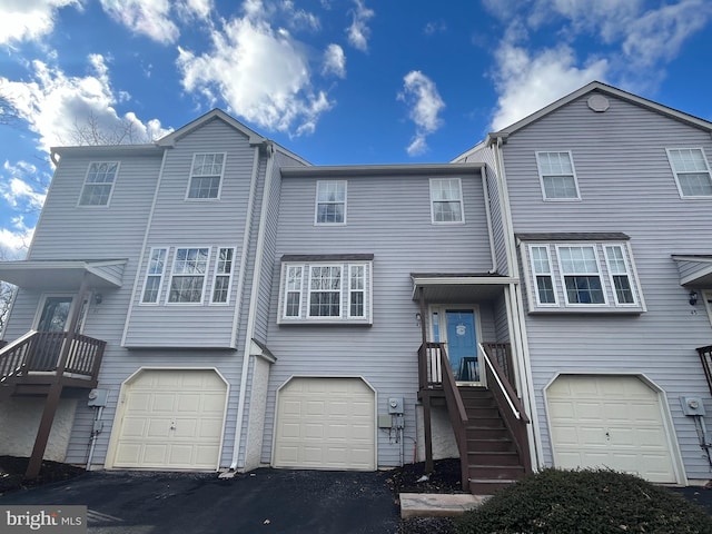 view of property with a garage and driveway